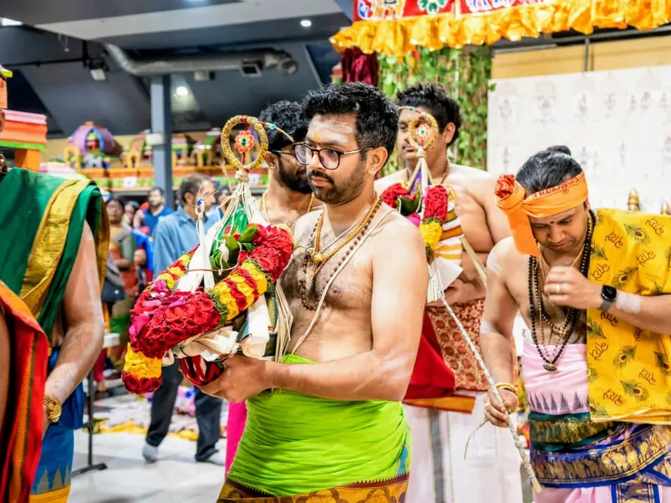 Temple procession with a flower decorated kavadi carried during a festival