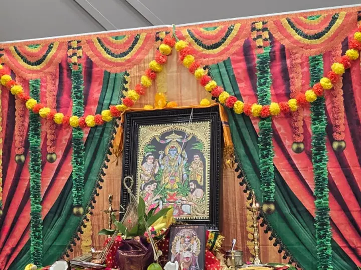 Decorated Satyanarayan Puja altar with marigold garlands, backdrops and offerings