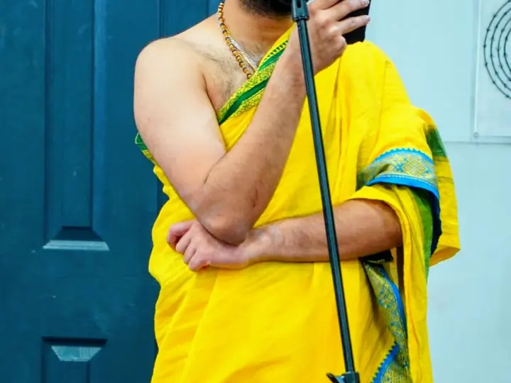 Purohit Surya chanting Vedic mantras at a community puja